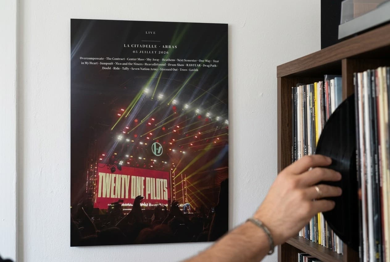 Print Dibond avec photo de concert et setlist complète accroché au mur près d'une étagère de vinyles